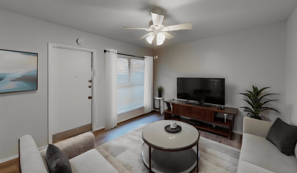 a living room with a couch and a table and a tv