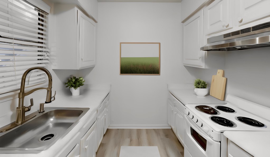 a kitchen with white cabinets and white appliances and a sink