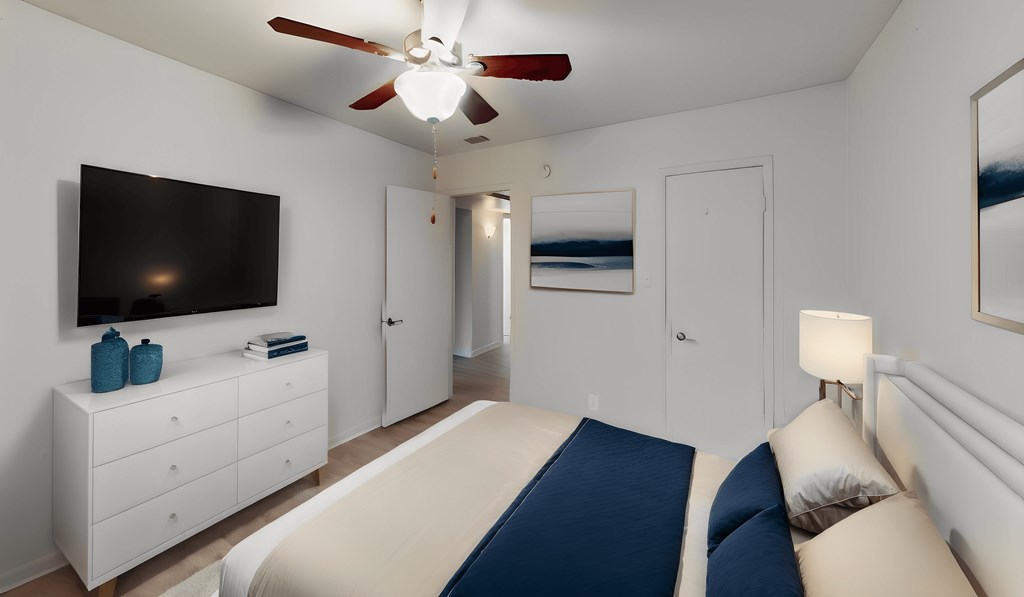 a bedroom with a bed and a ceiling fan