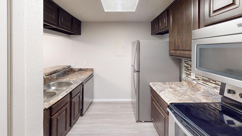 a kitchen with a stove microwave and refrigerator