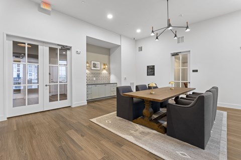 A modern dining room with a wooden table and chairs.