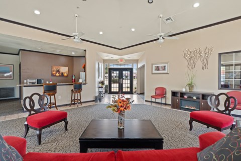 A living room with a red couch and a black coffee table.
