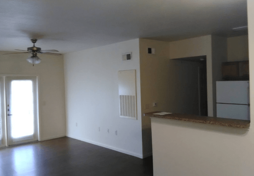 A room with a ceiling fan and a window.