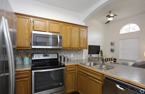 A kitchen with wooden cabinets and stainless steel appliances.