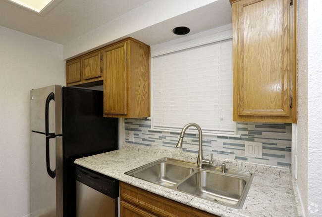 a kitchen with a sink and a refrigerator