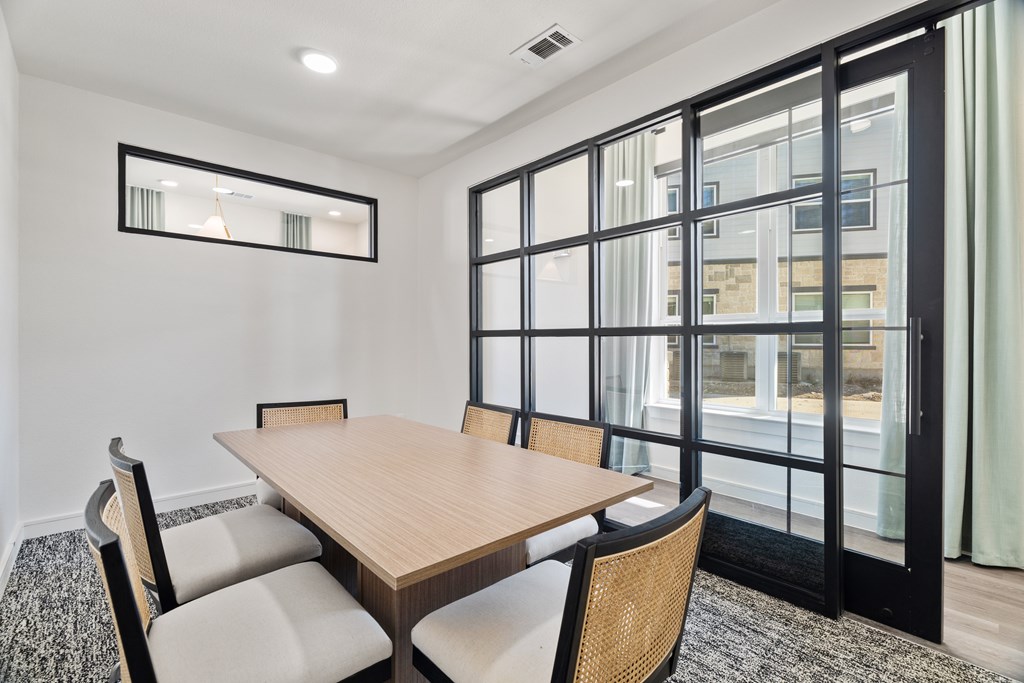A dining room with a wooden table and chairs. A dining room with a wooden table and chairs. at SOSA at Palo Alto Apartments, San Antonio, TX, 78224