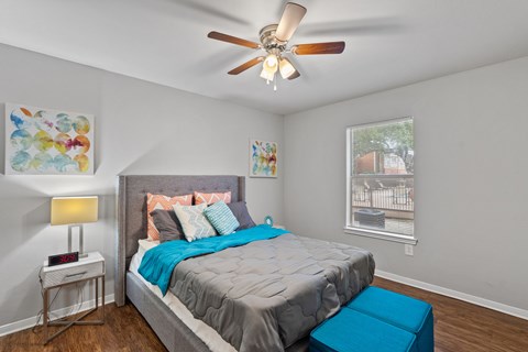 Spacious bedroom with wood floor and large window1 at Country Oaks Apartments, San Marcos, TX