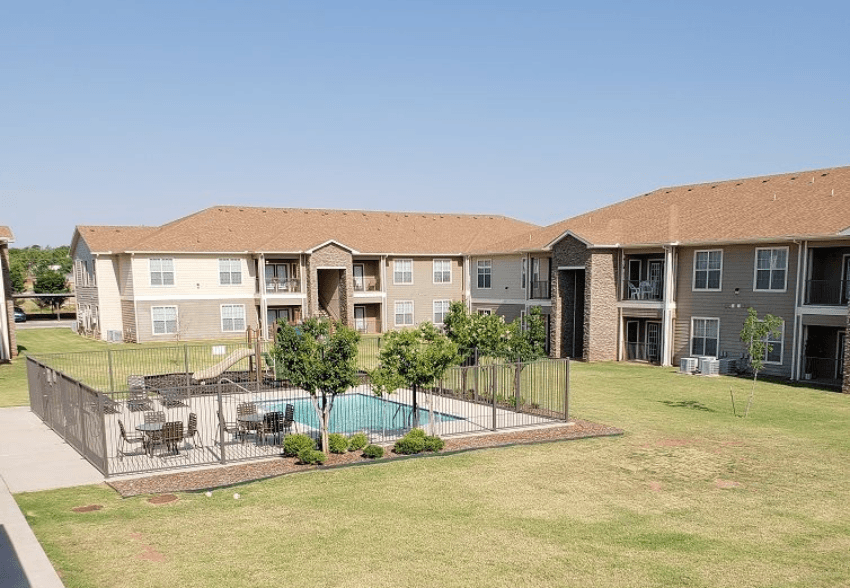 Apartment complex with a pool in the middle.
