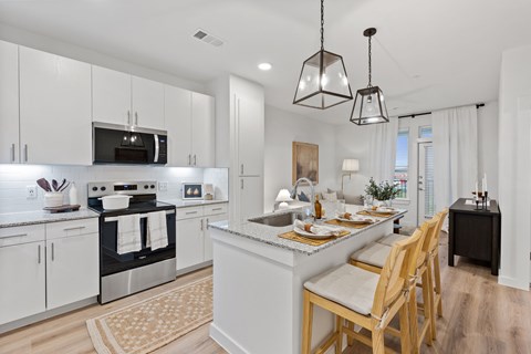 A modern kitchen with a dining table set for four.