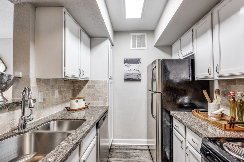 a kitchen with stainless steel appliances and granite counter tops