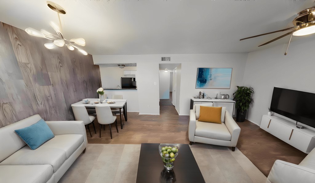 a living room and dining room with couches and a table