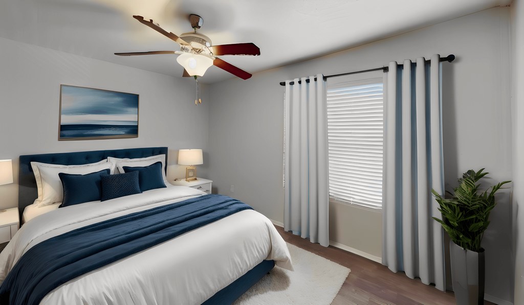 a bedroom with a large bed and a ceiling fan