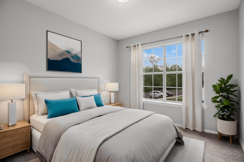 furnished bedroom with white bedding and a window with a plant