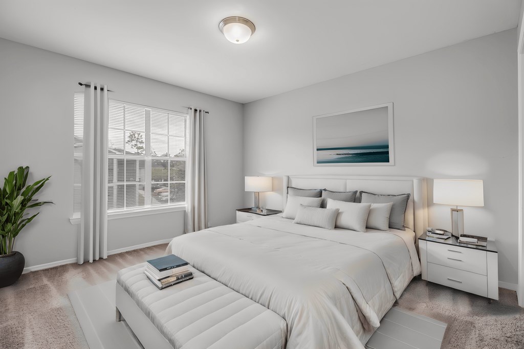 a white bedroom with a large bed and a window