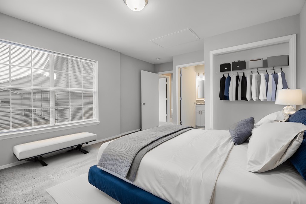 a bedroom with a bed and a window and a closet