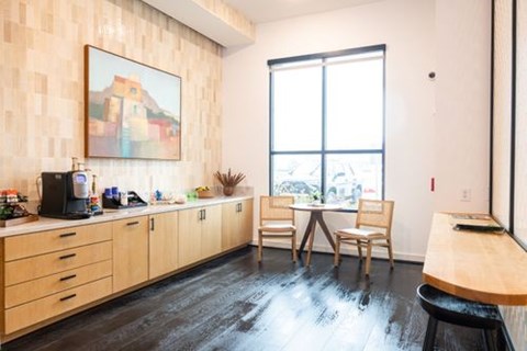 A kitchen with wooden cabinets and a painting on the wall.