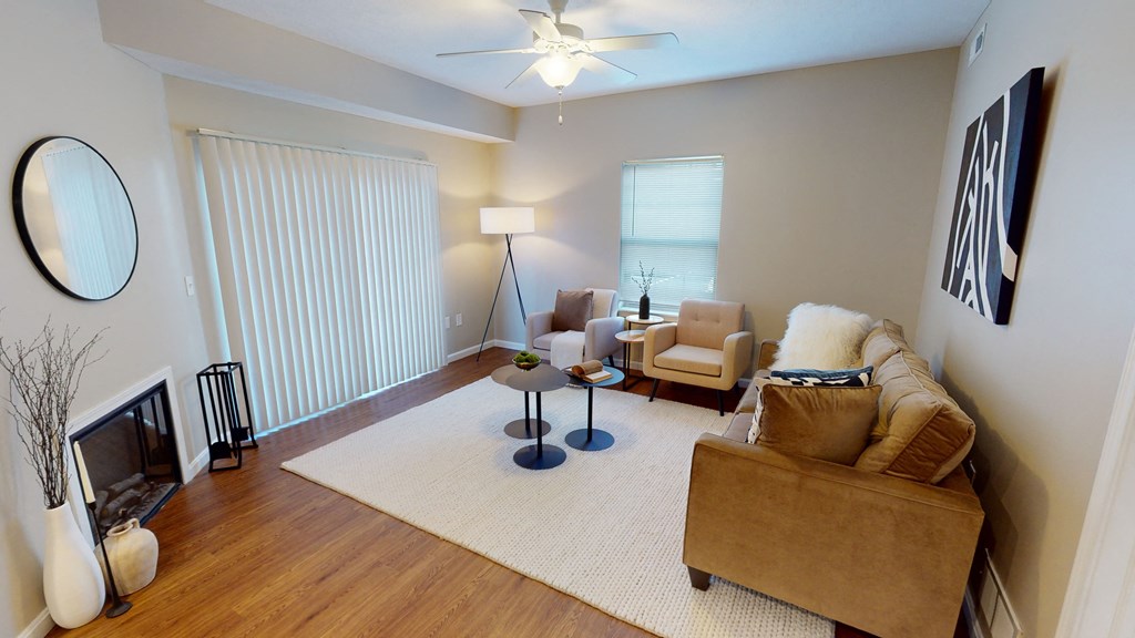 a living room with a couch chairs and a fire place