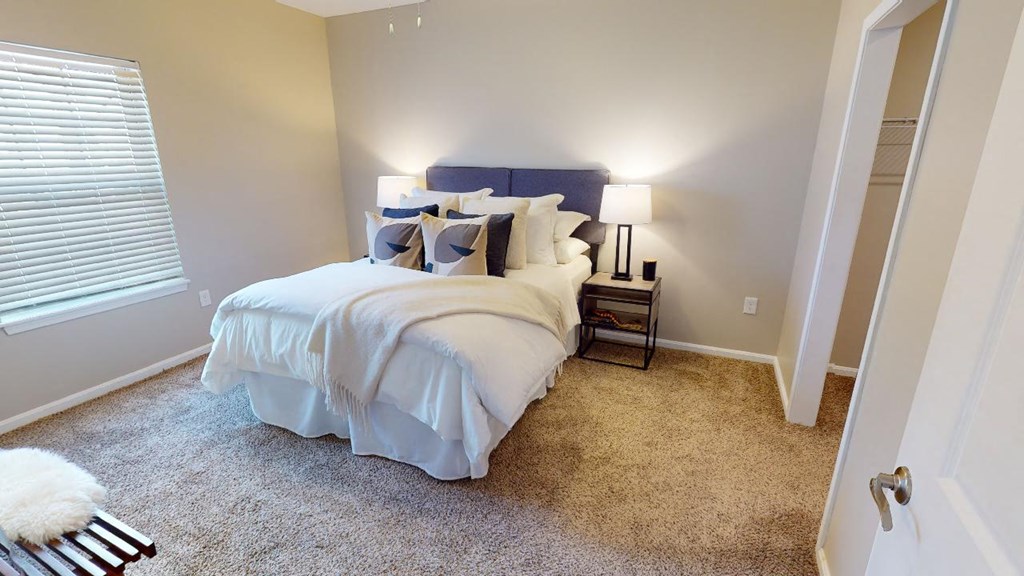 a bedroom with a bed and a window