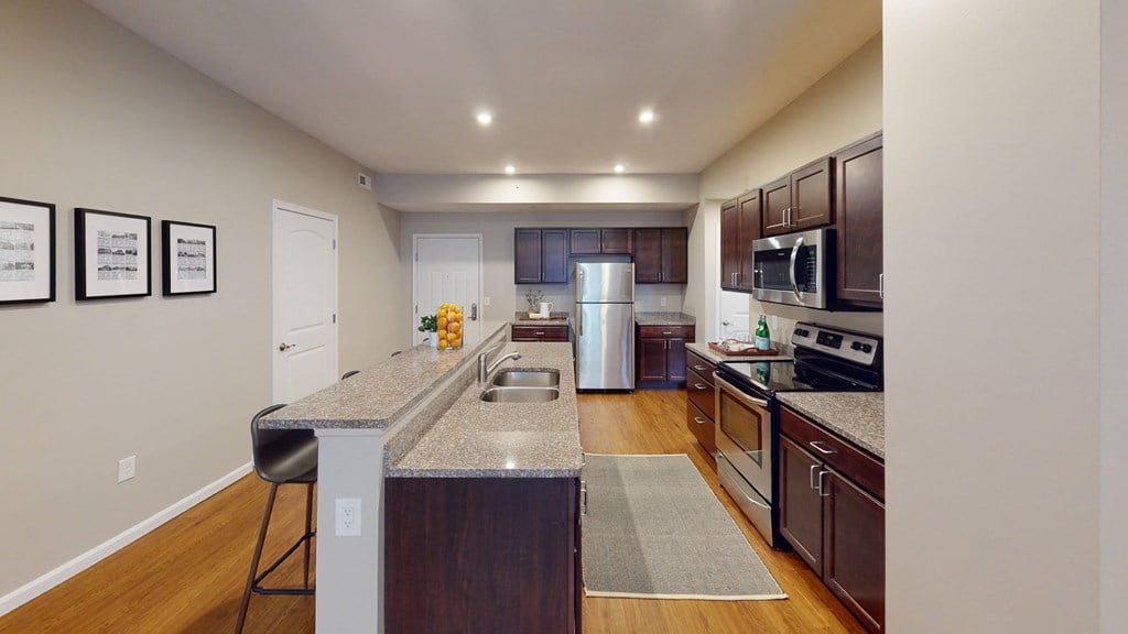 a kitchen with granite countertops and stainless steel appliances
