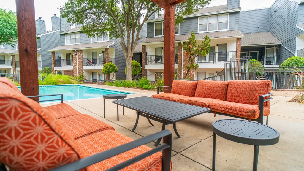 our apartments have a large pool and a patio with furniture