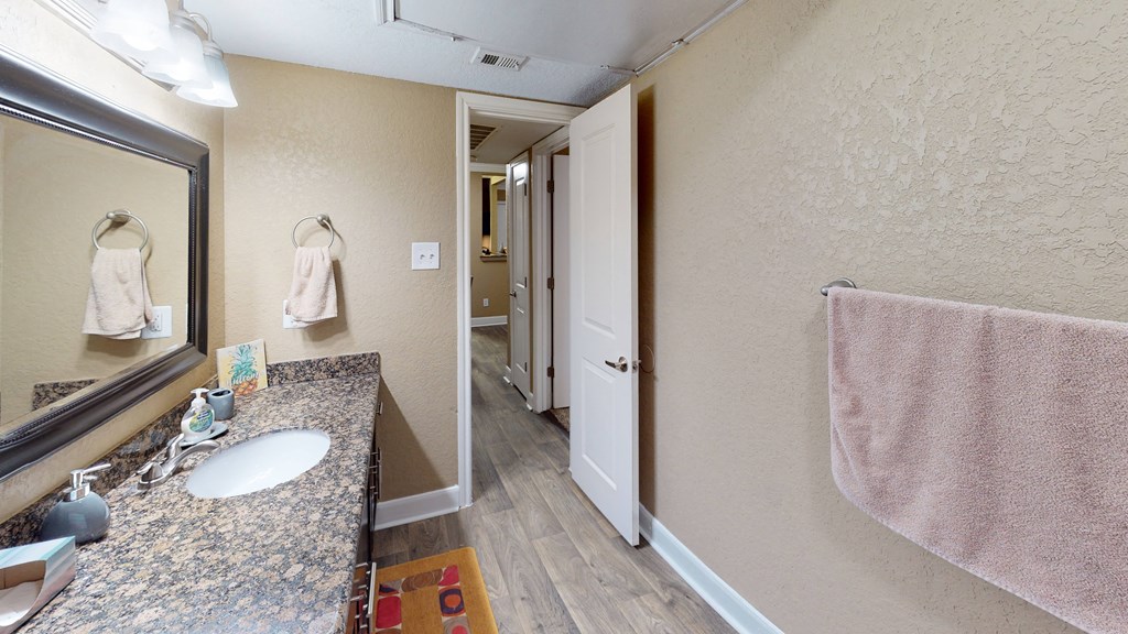 a bathroom with a sink and a mirror in a hotel room