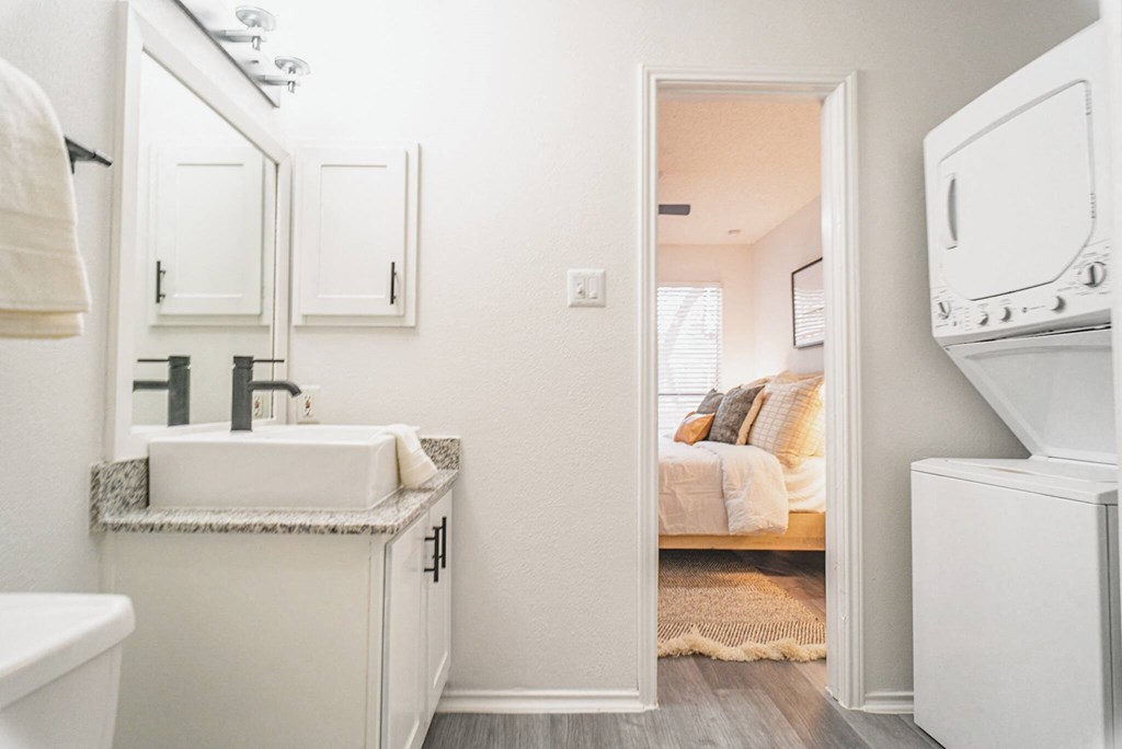 a small laundry room with a sink and a washer and dryer