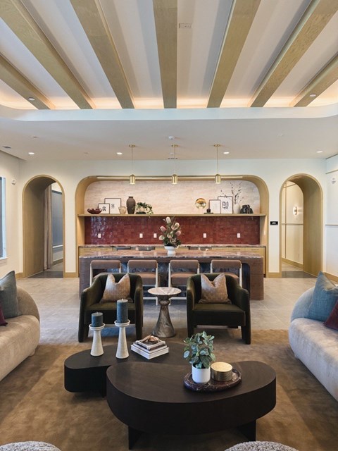 A modern living room with a large coffee table and comfortable seating.