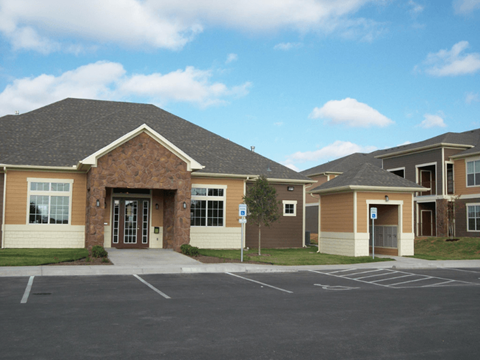 A building with a parking lot in front of it.