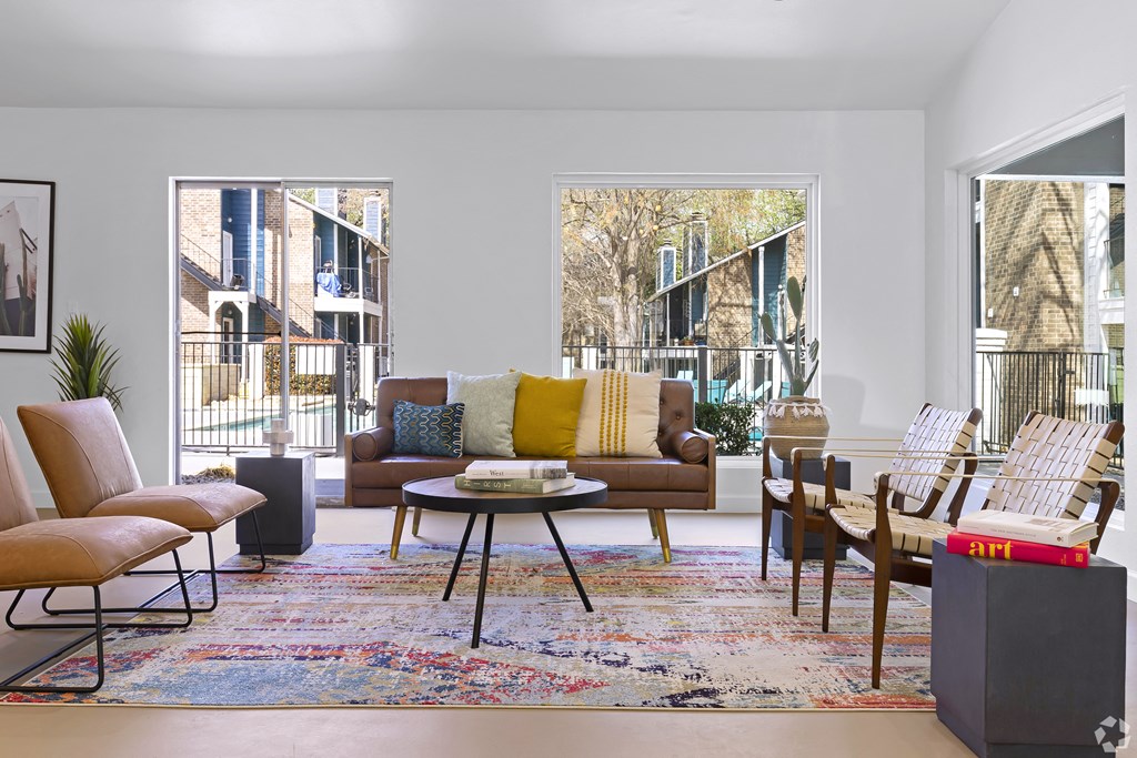 a living room with couches chairs and a rug