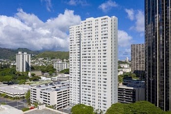 a tall white building sitting in the middle of a city