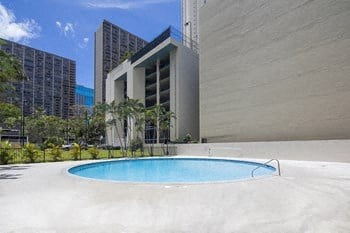 a swimming pool in front of a large building