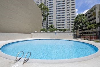 a swimming pool with a building in the background
