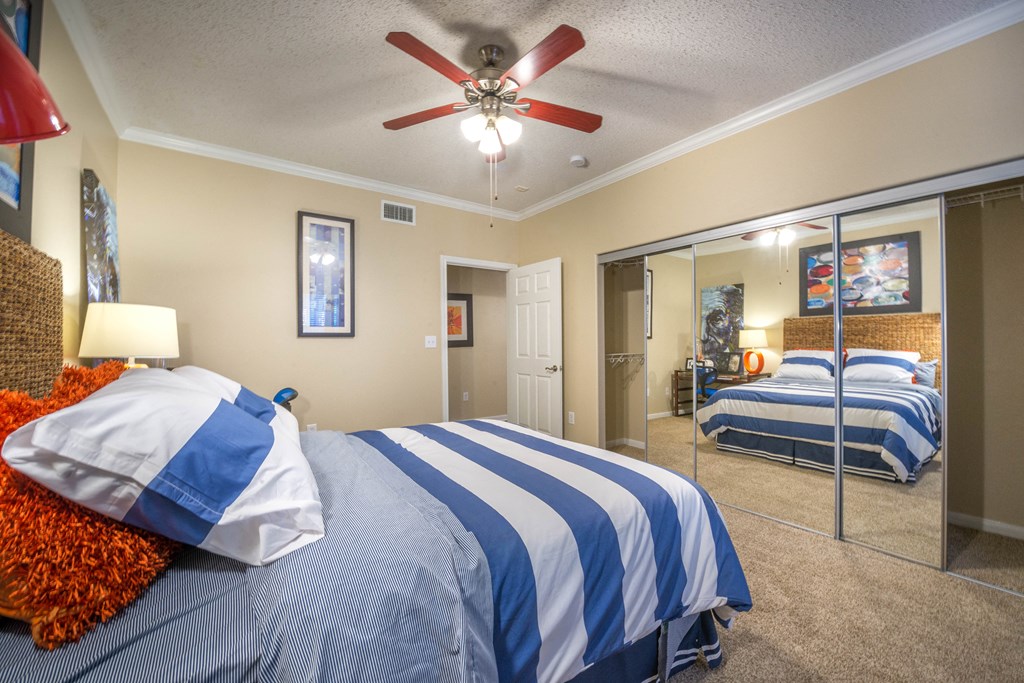 a bedroom with two beds and a ceiling fan