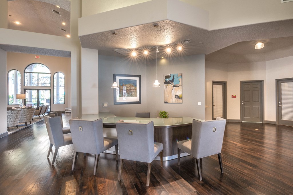 a dining room with a large table and chairs and a living room with couches