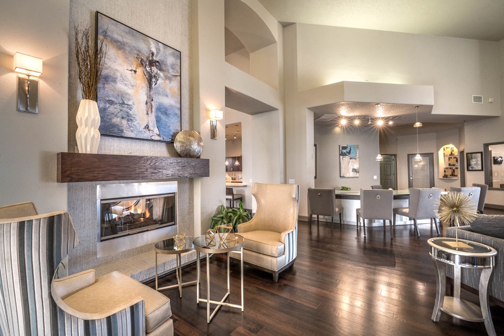 a living room with a fireplace and a table with chairs