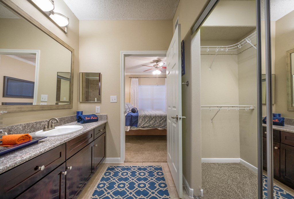 a bathroom with a shower and a sink and a mirror