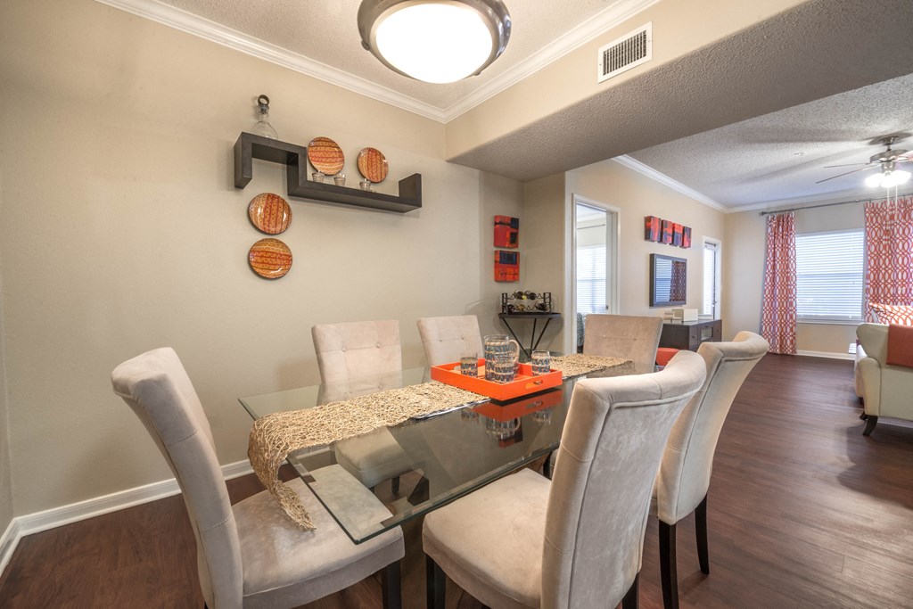 a dining room with a table and chairs and a window