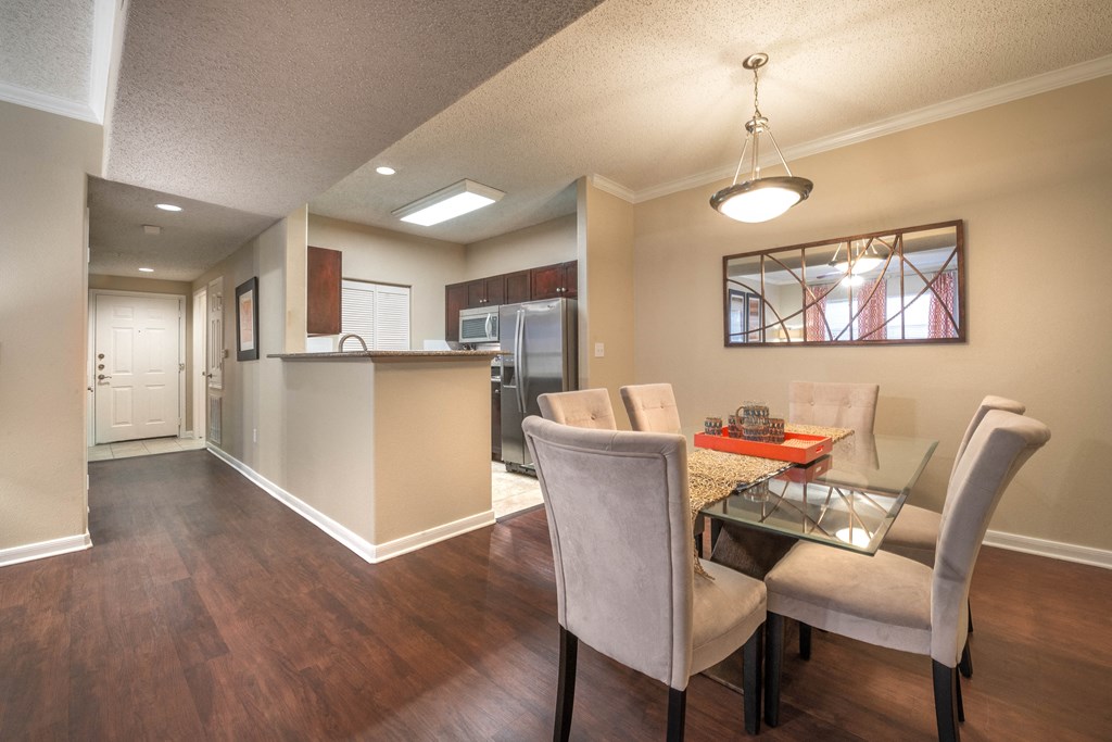 a dining room and kitchen with a table and chairs