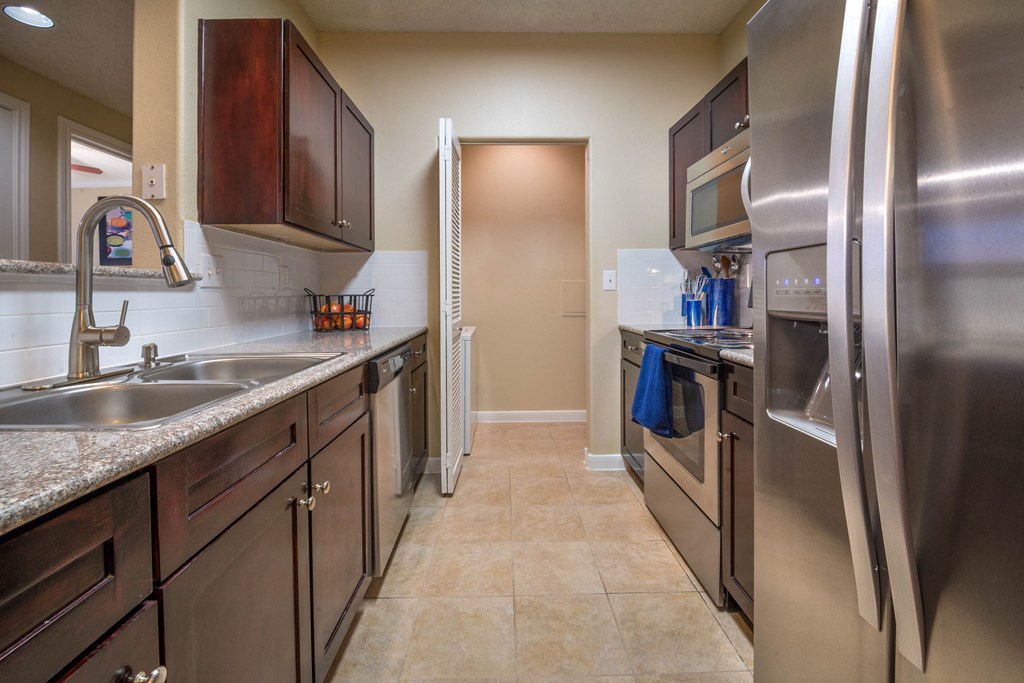 a kitchen with stainless steel appliances and granite counter tops