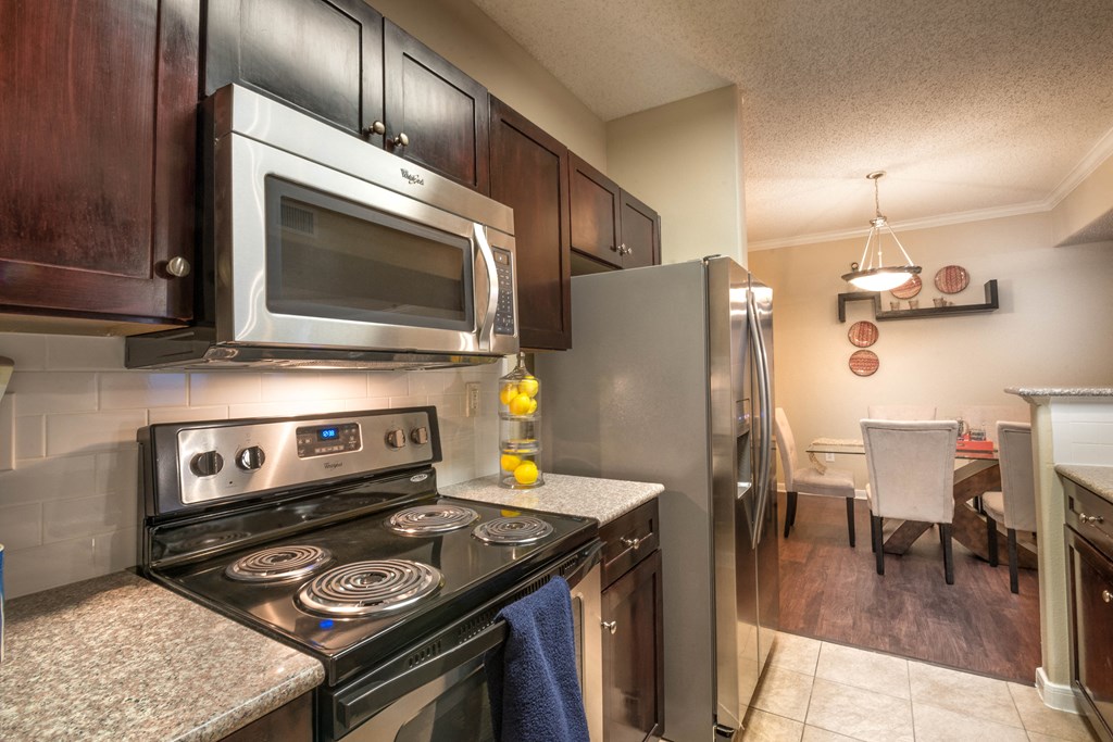 a kitchen with stainless steel appliances and granite counter tops