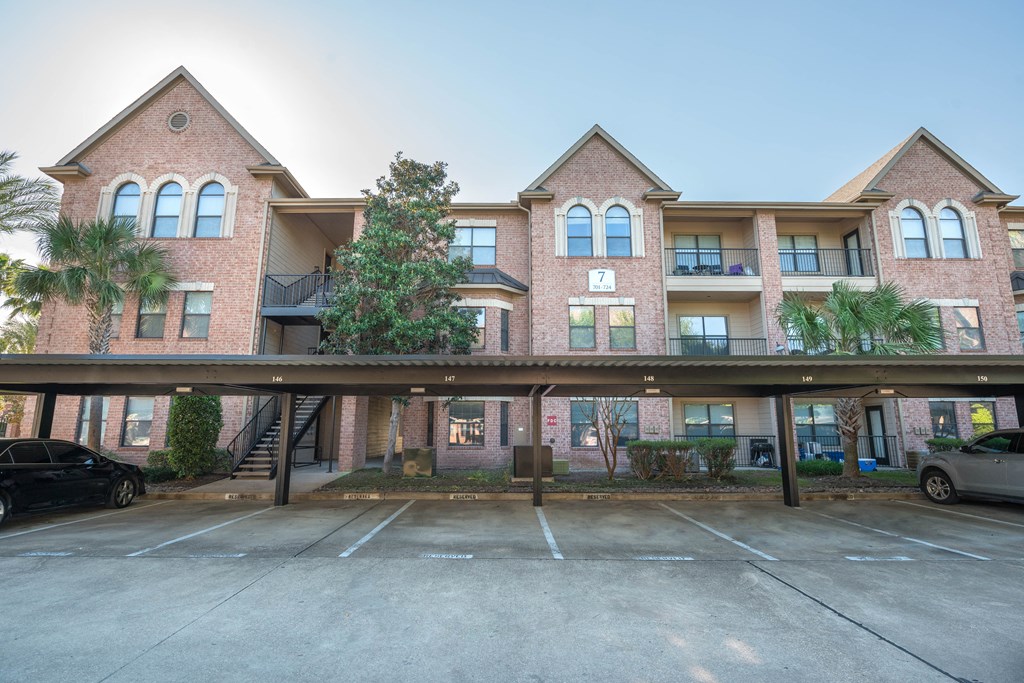 an empty parking lot in front of an apartment building