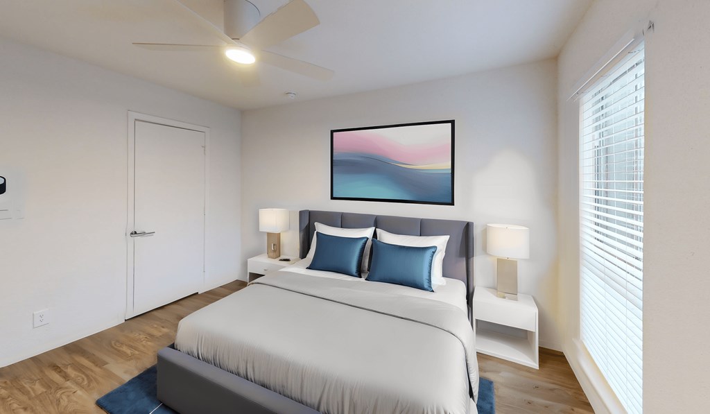 a bedroom with a large bed and a ceiling fan