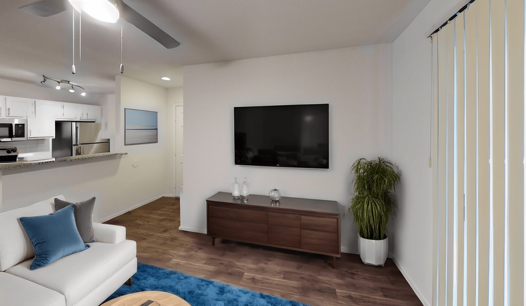 a living room with a white couch and a tv