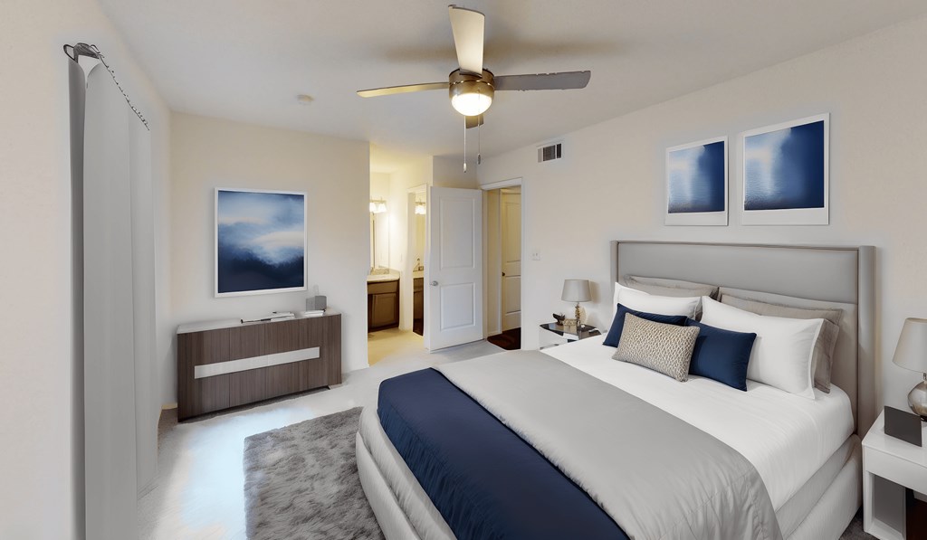 a bedroom with a large bed and a ceiling fan