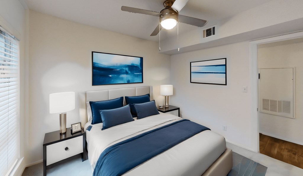 a bedroom with a large bed and a ceiling fan