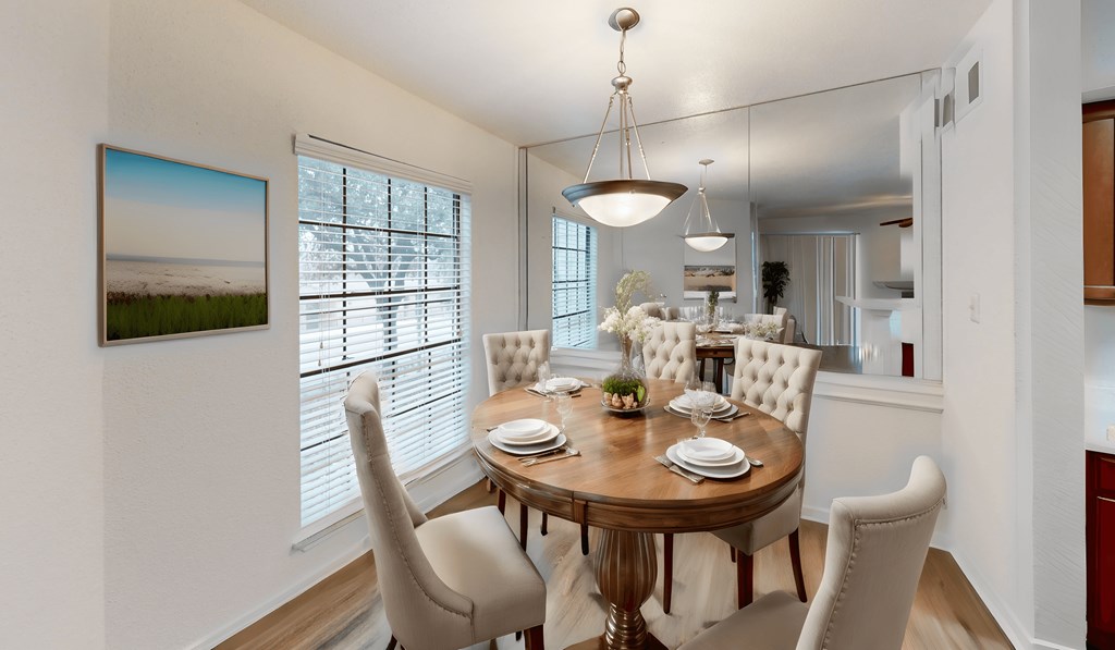 a dining room with a wooden table and chairs