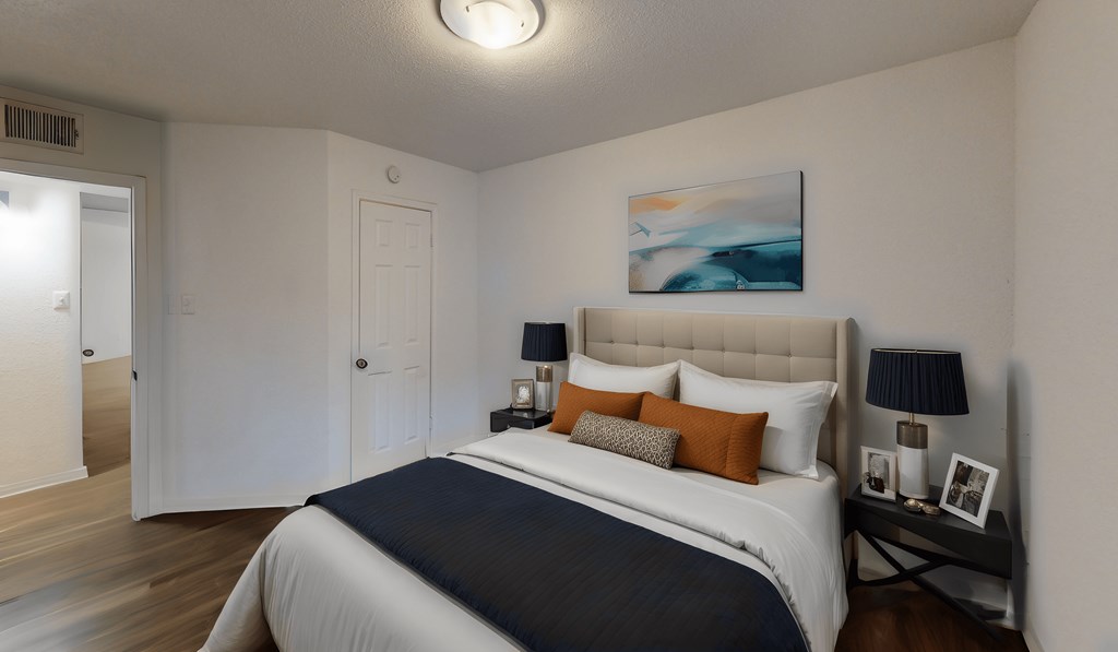 a bedroom with a bed and a door to a bathroom