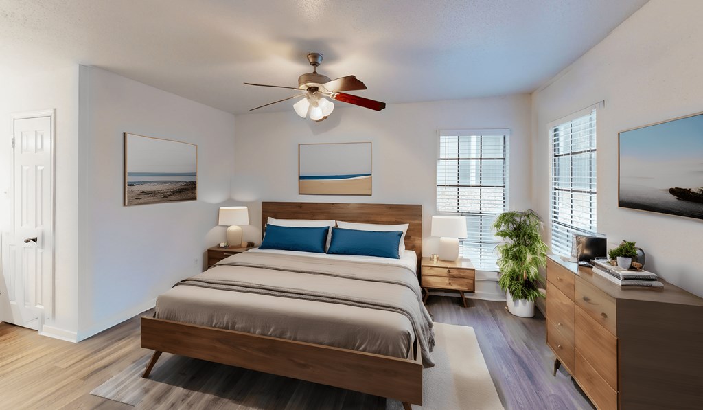 a bedroom with a bed and a ceiling fan