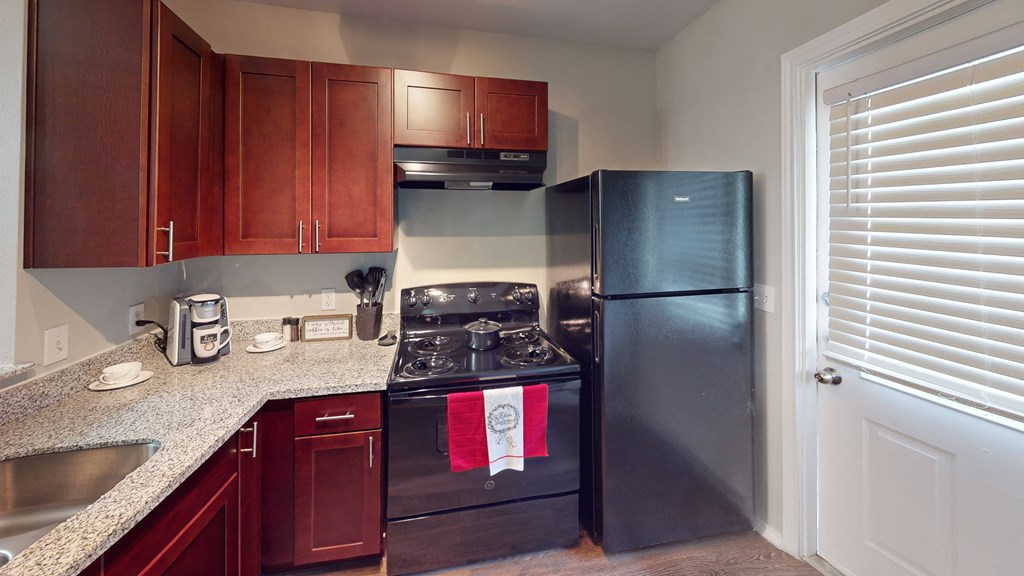 a kitchen with stainless steel appliances and granite counter tops