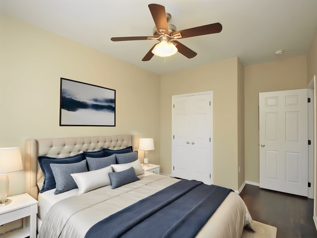 a bedroom with a large bed and a ceiling fan